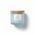Sea Breeze soy candle in frosted blue glass jar with bamboo lid on white background