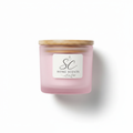 Freesia soy candle in frosted pink glass jar with bamboo lid on white background